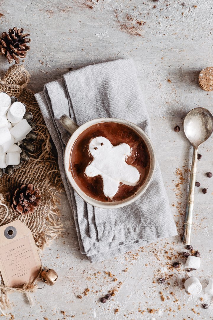 Gingerbread marshmallow on top of creamy gluten free hot chocolate into a mug