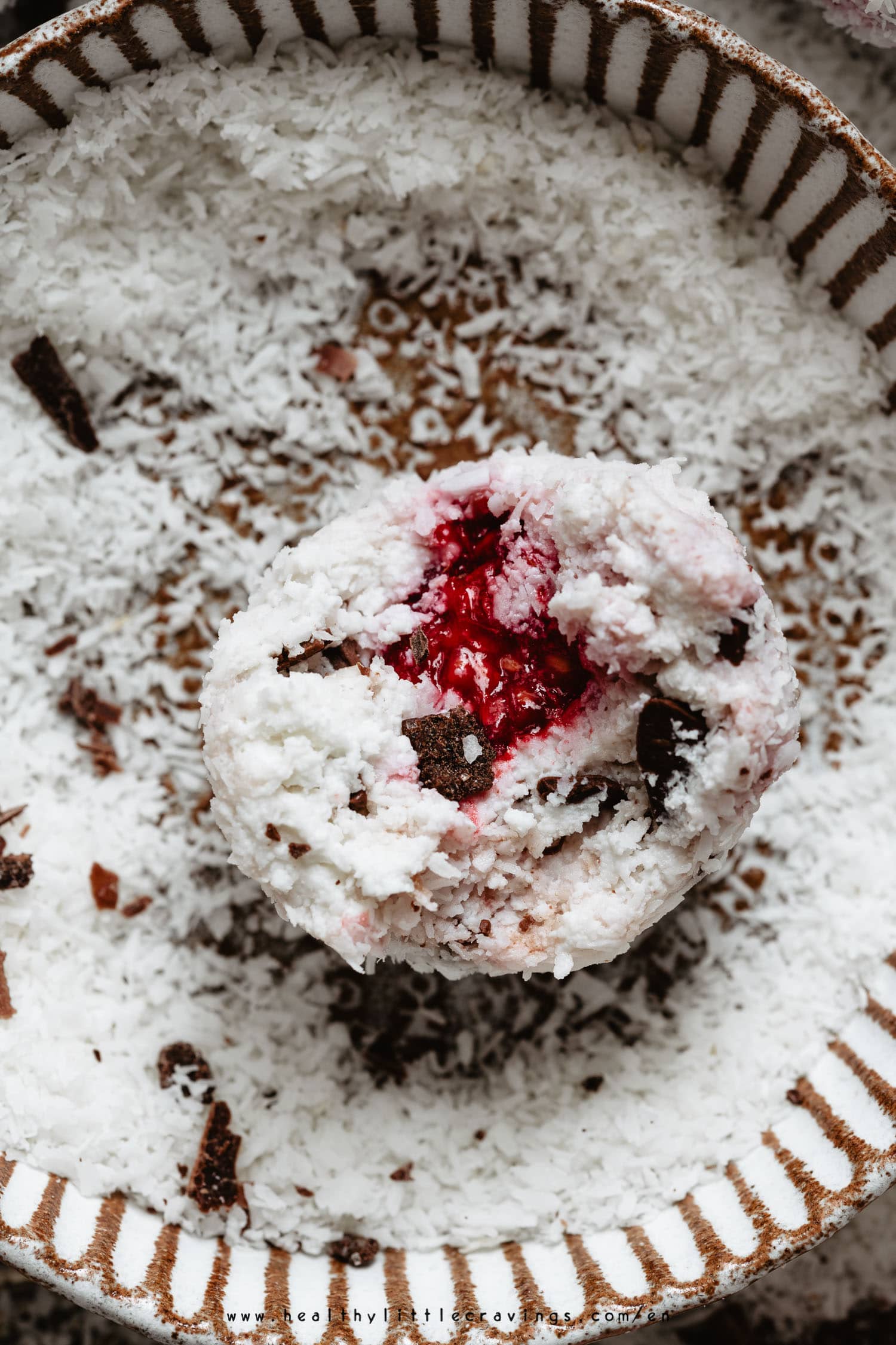 Closeup of coconut balls with raspberry in the center