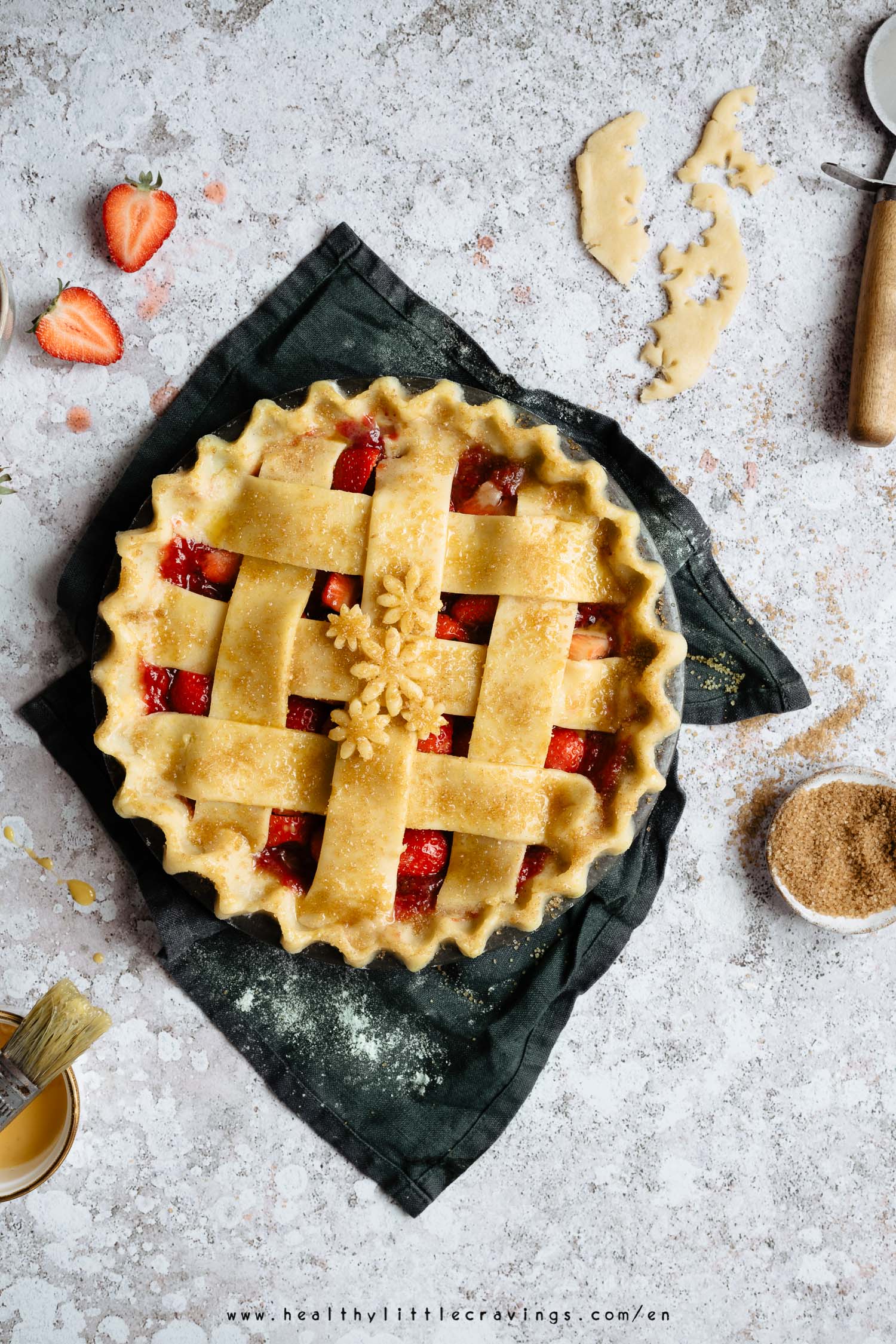 A raw strawberry pie with cinnamon sugar sprinkled on top, onto a green napkin