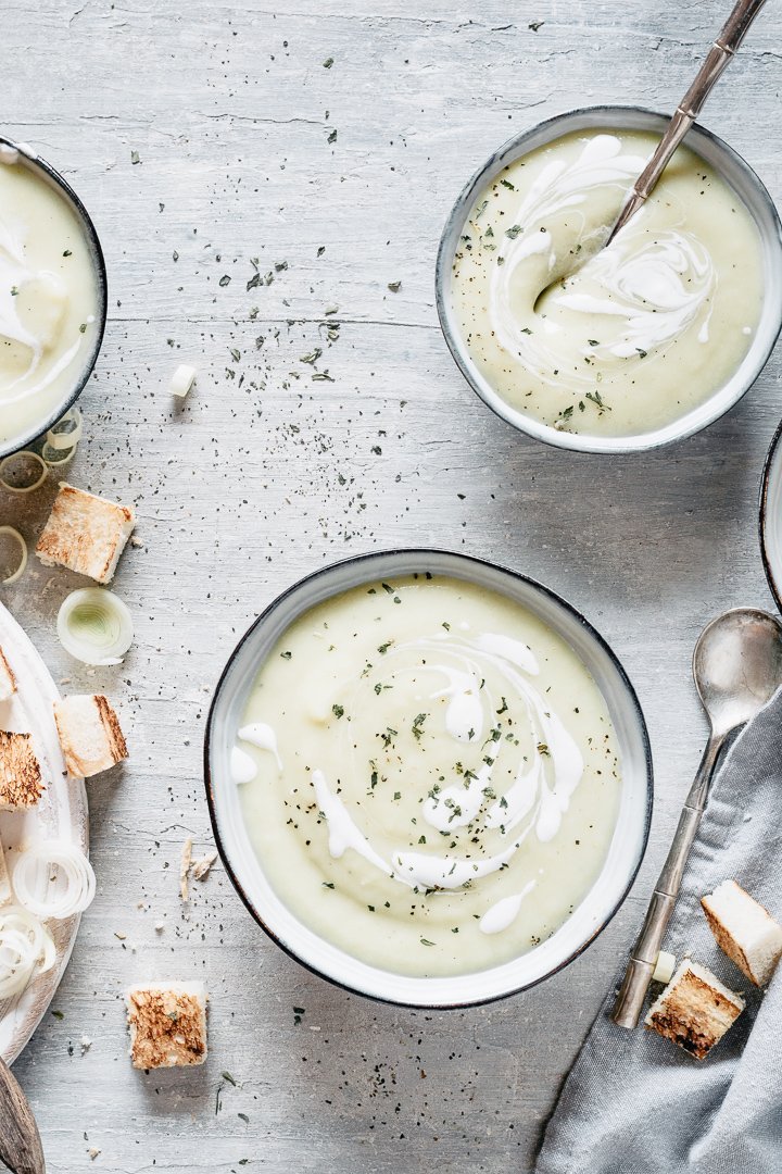 Creamy velvety potato leek soup served with bread and cream cheese
