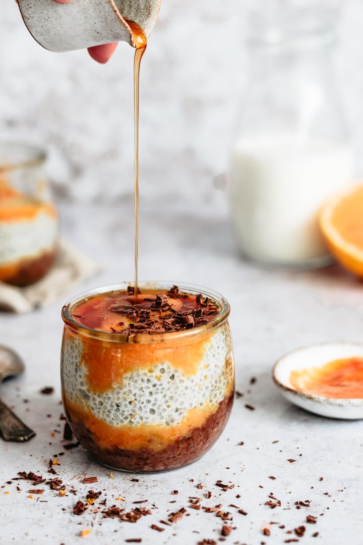 Chocolate chia pudding with orange purée served with maple syrup 