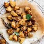 Extra crispy roasted potatoes on slightly burnt parchment paper