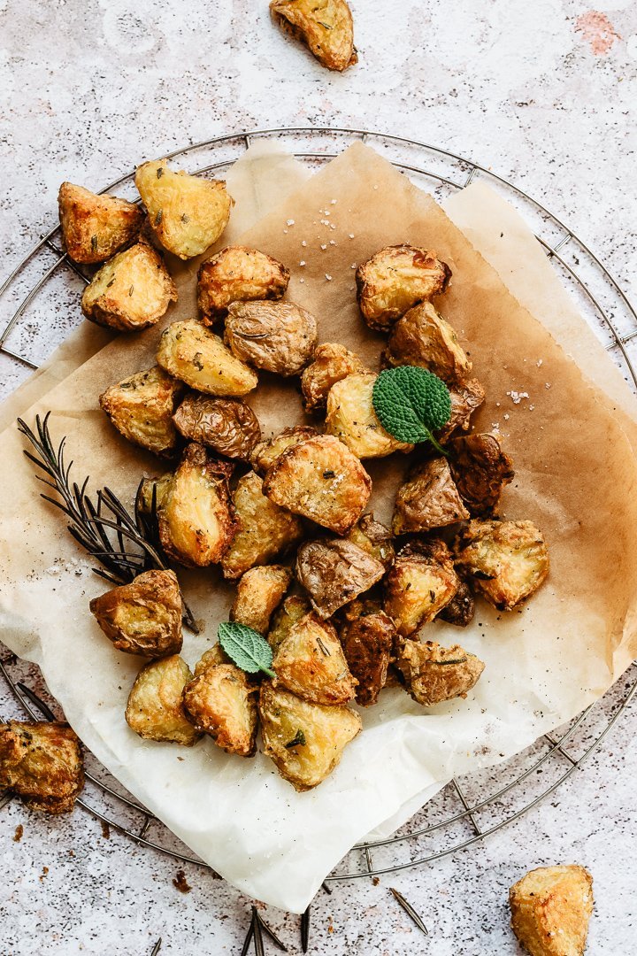 Extra crispy roasted potatoes on slightly burnt parchment paper