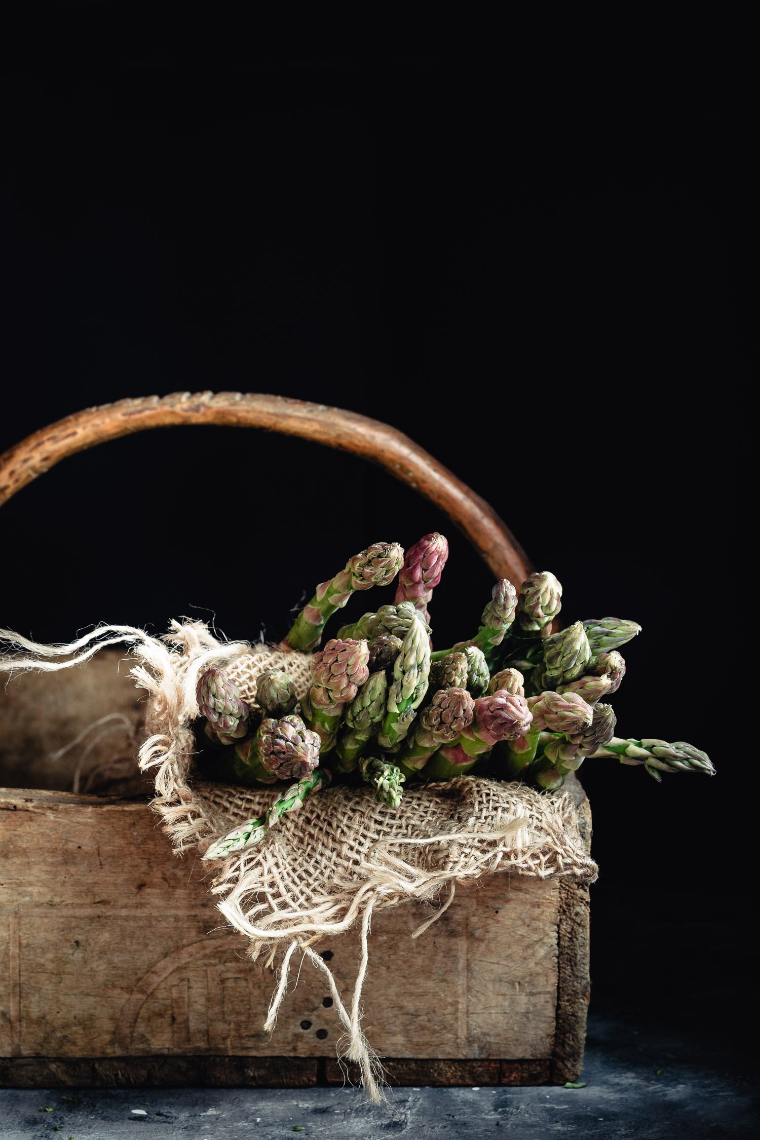 Raw asparagus into a basket