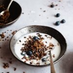 A bowl of yogurt and chocolate granola - learn how to make vanilla yogurt at home!