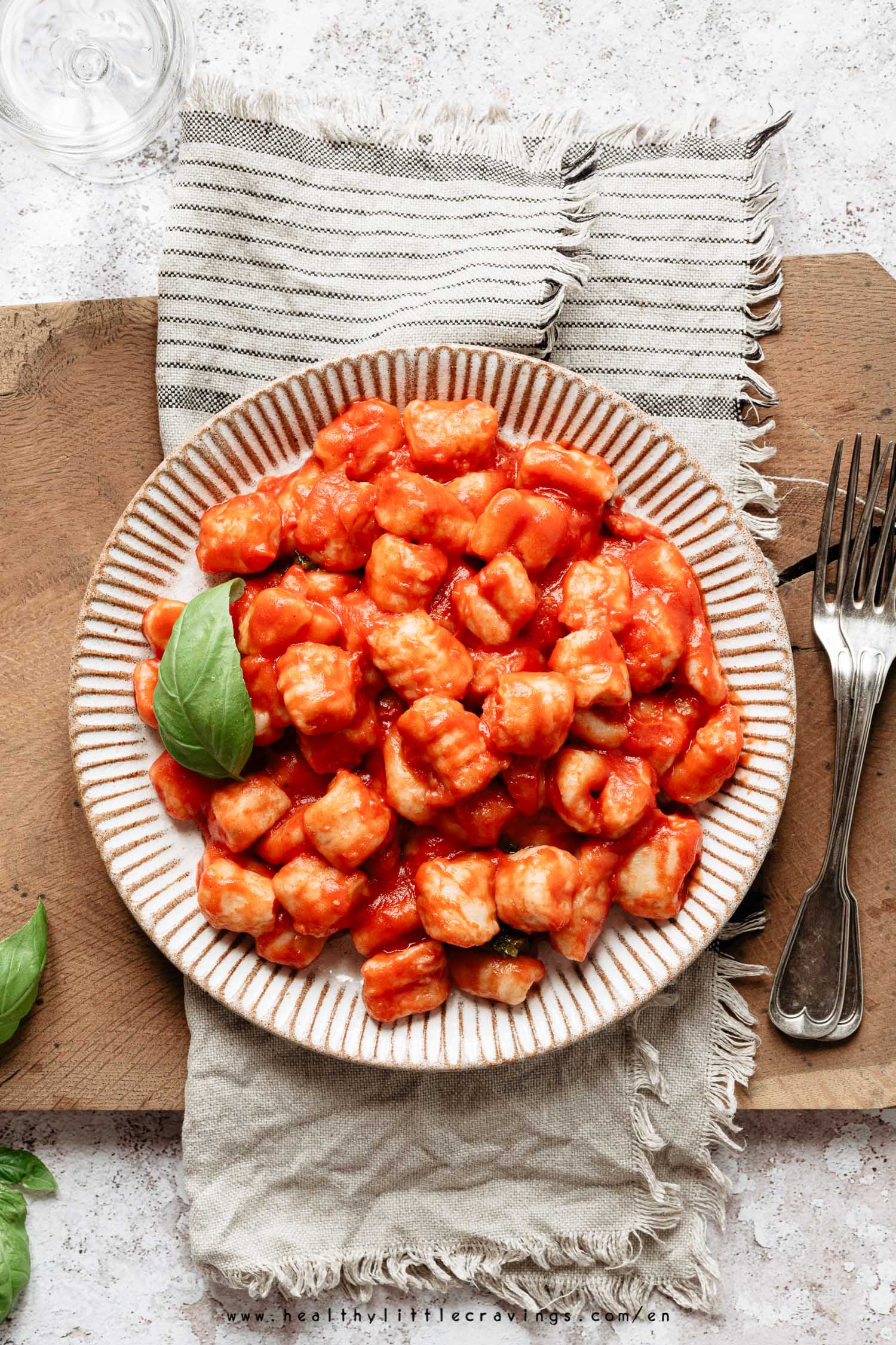 A plate full of vegan gnocchi with tomato sauce