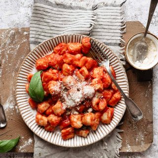 A plate of italian gnocchi with parmesan cheese