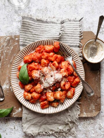 A plate of italian gnocchi with parmesan cheese
