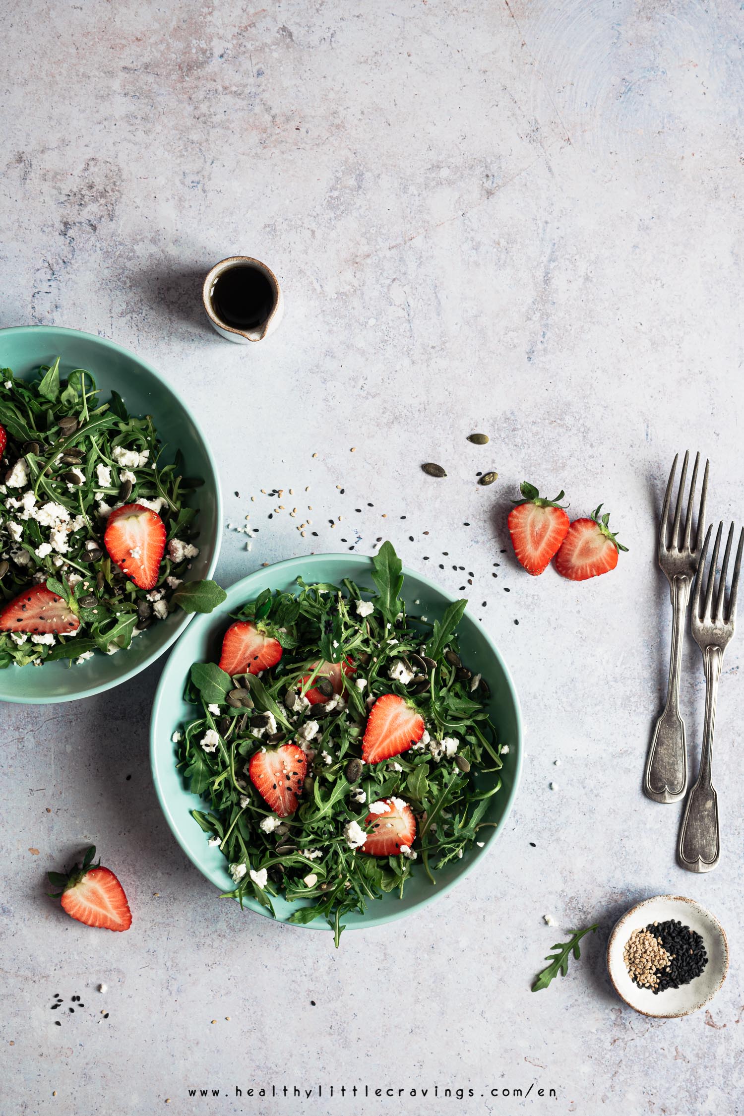 Strawberry arugula salad served into green plates