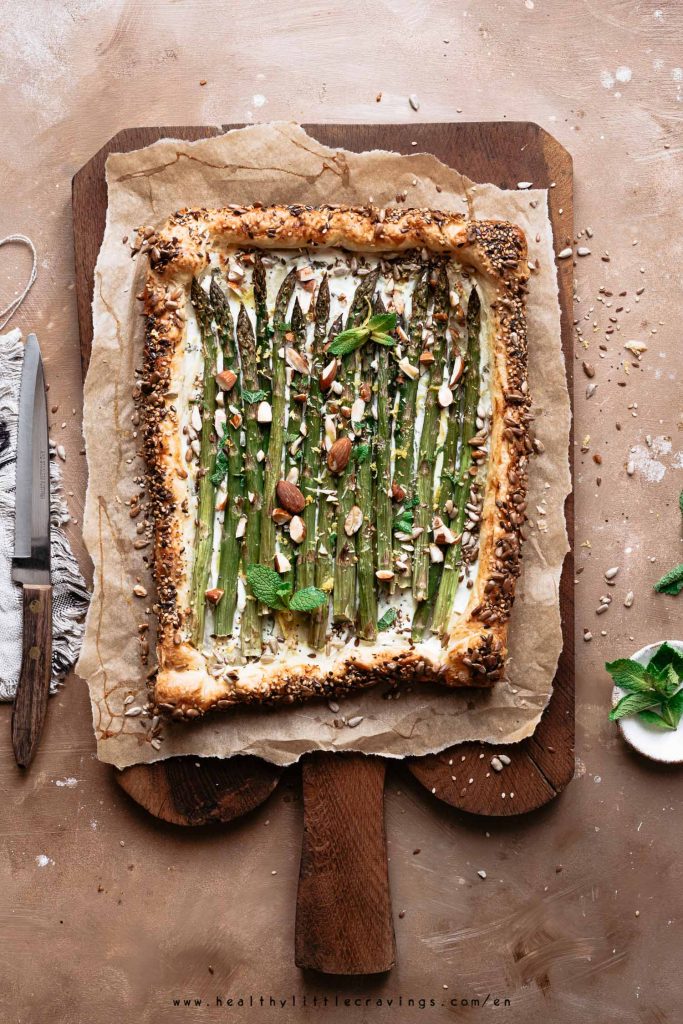 Asparagus tart on a rustic wooden cutting board