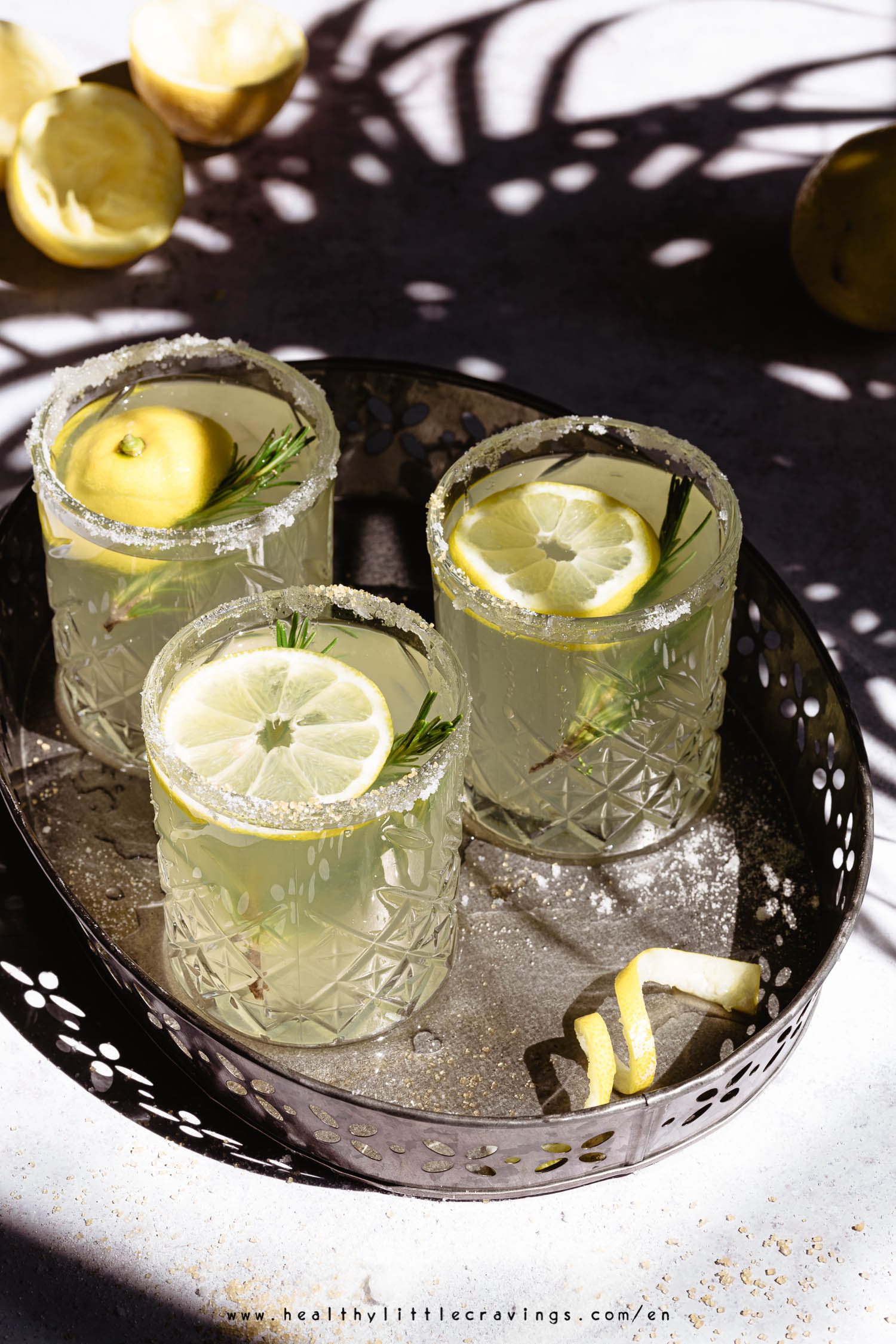 Refreshing rosemary lemonade into 3 glasses