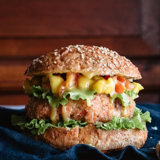 Closeup of grilled salmon burger with mustard and honey