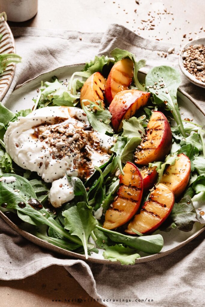 A grilled peach salad with burrata, seeds and vinaigrette