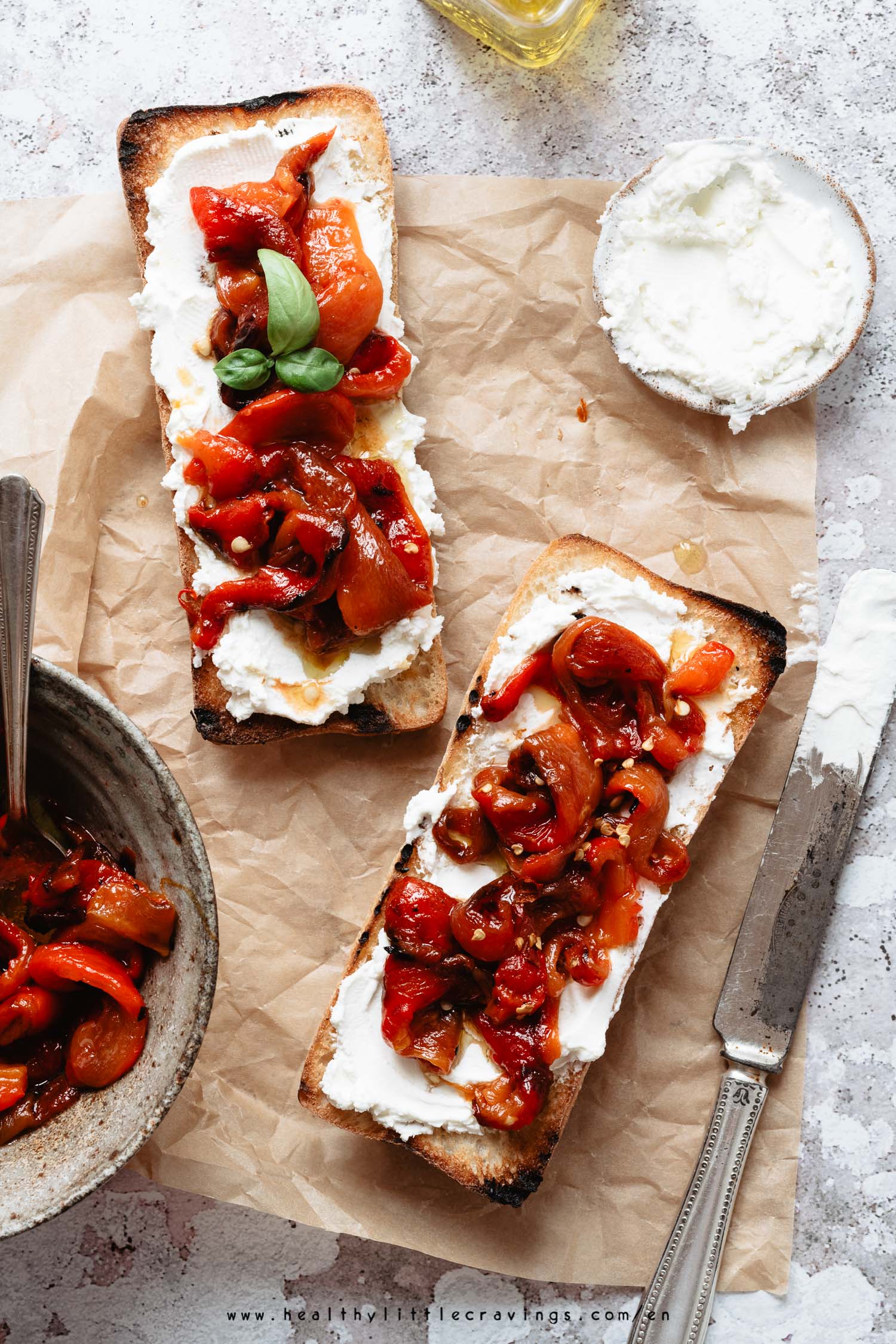 Delicious toast with robiola cheese and oven roasted peppers in olive oil