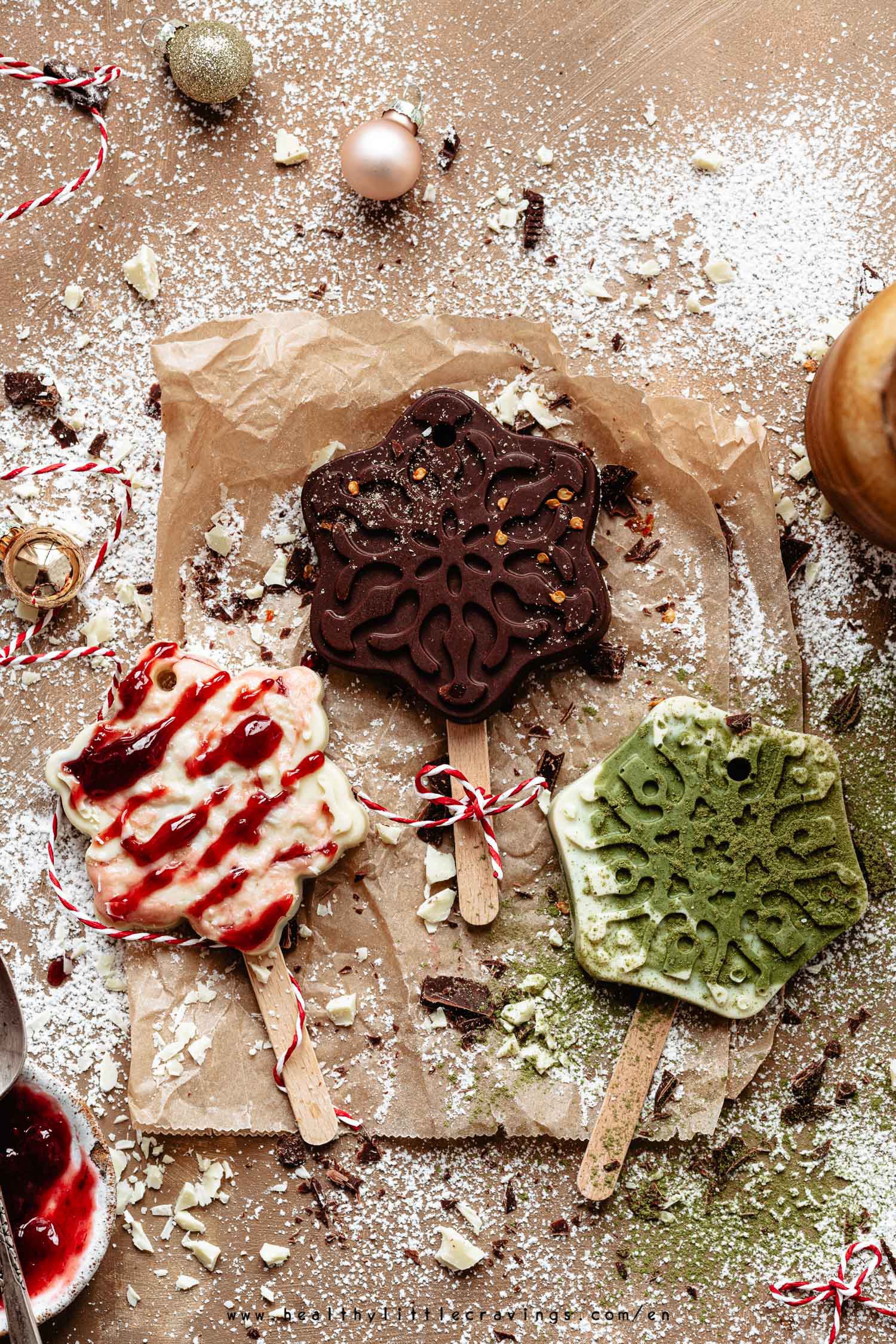 Three hot chocolate on stick on parchment paper flat-lay