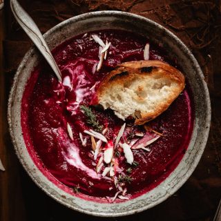 Baguette on a beet soup into a bowl