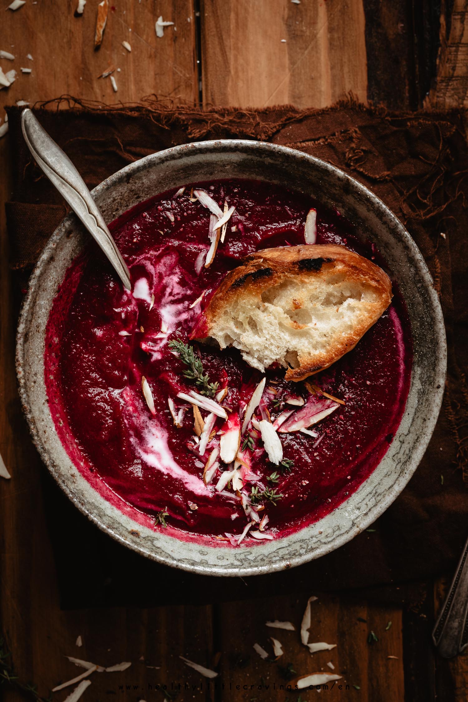 Baguette on a beet soup into a bowl