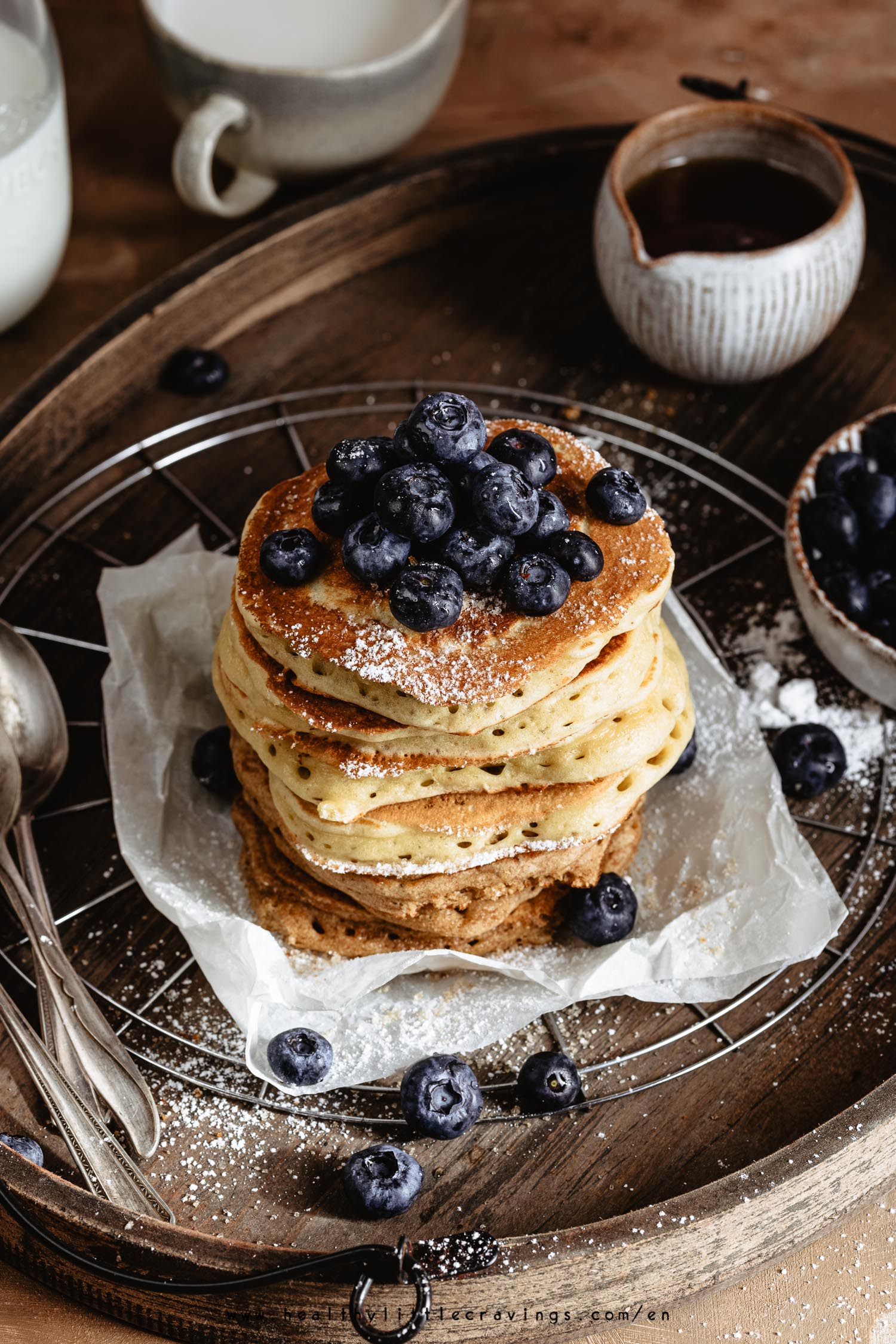 A delicious stack of fluffy pancakes on a piece of parchment paper. Learn how to make fluffy pancakes