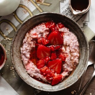 Vanilla strawberry oatmeal into a ceramic bowl