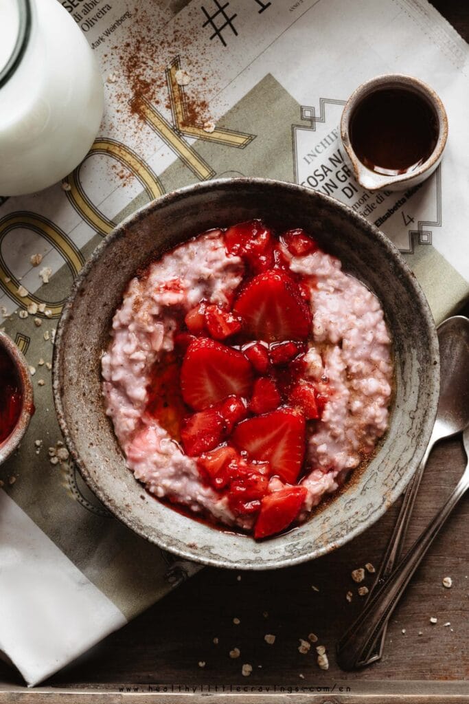 Vanilla strawberry oatmeal into a ceramic bowl