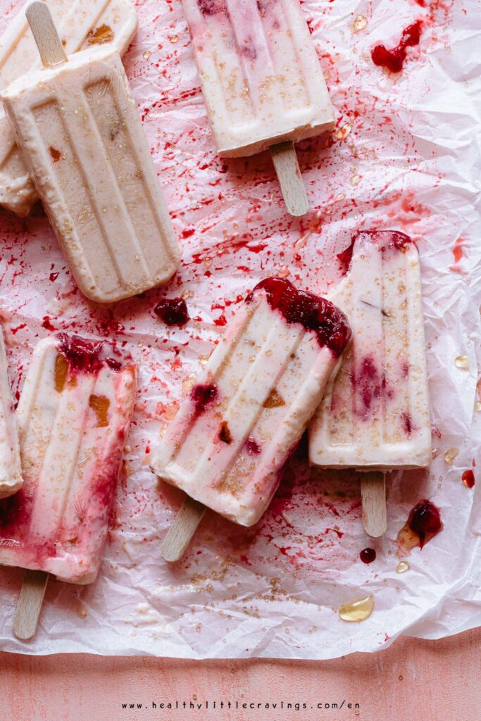 Yogurt popsicles on a orange backdrop