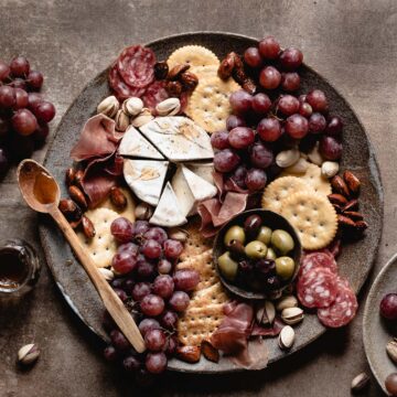 charcuterie cheese board on a brown backdrop