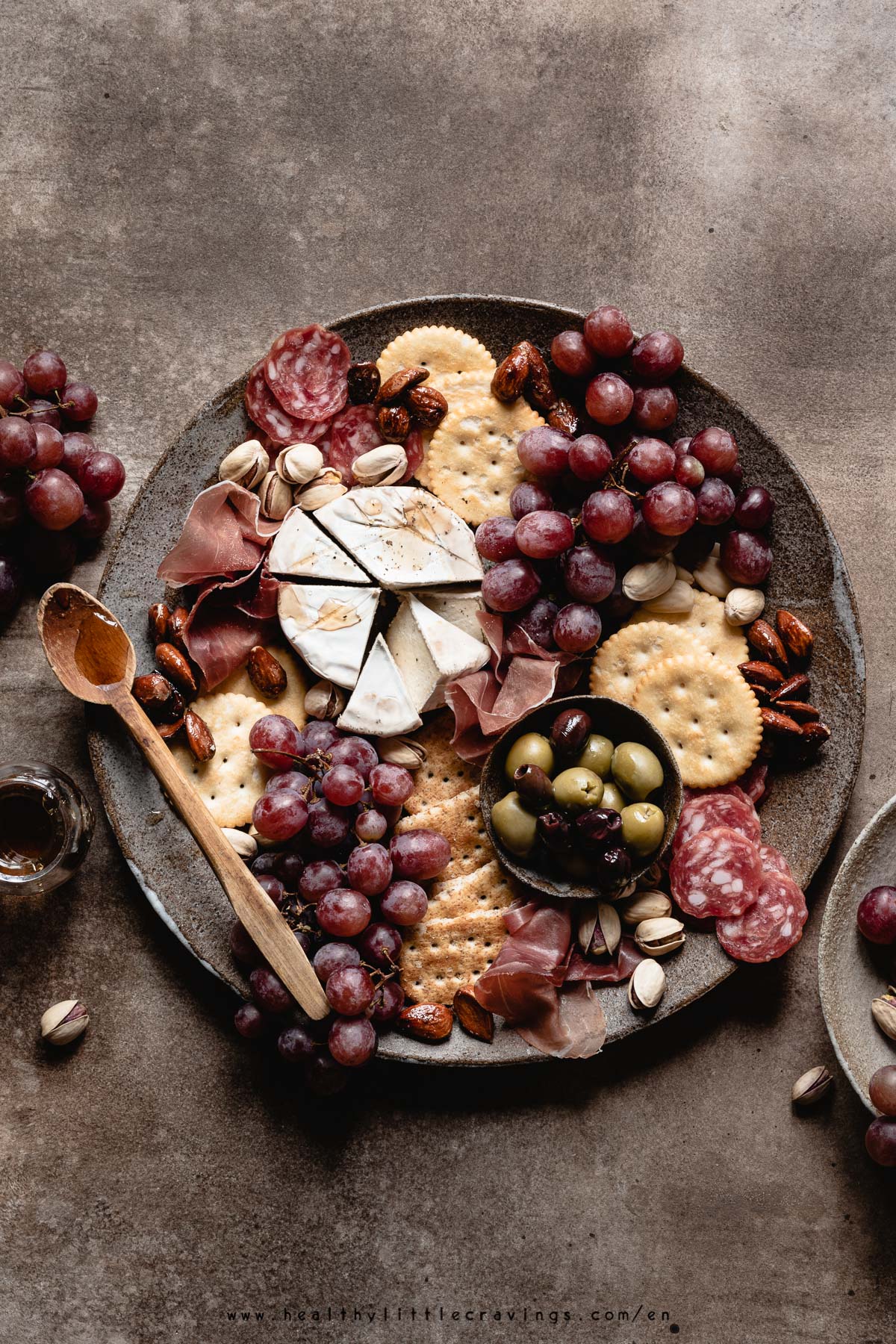 charcuterie cheese board on a brown backdrop