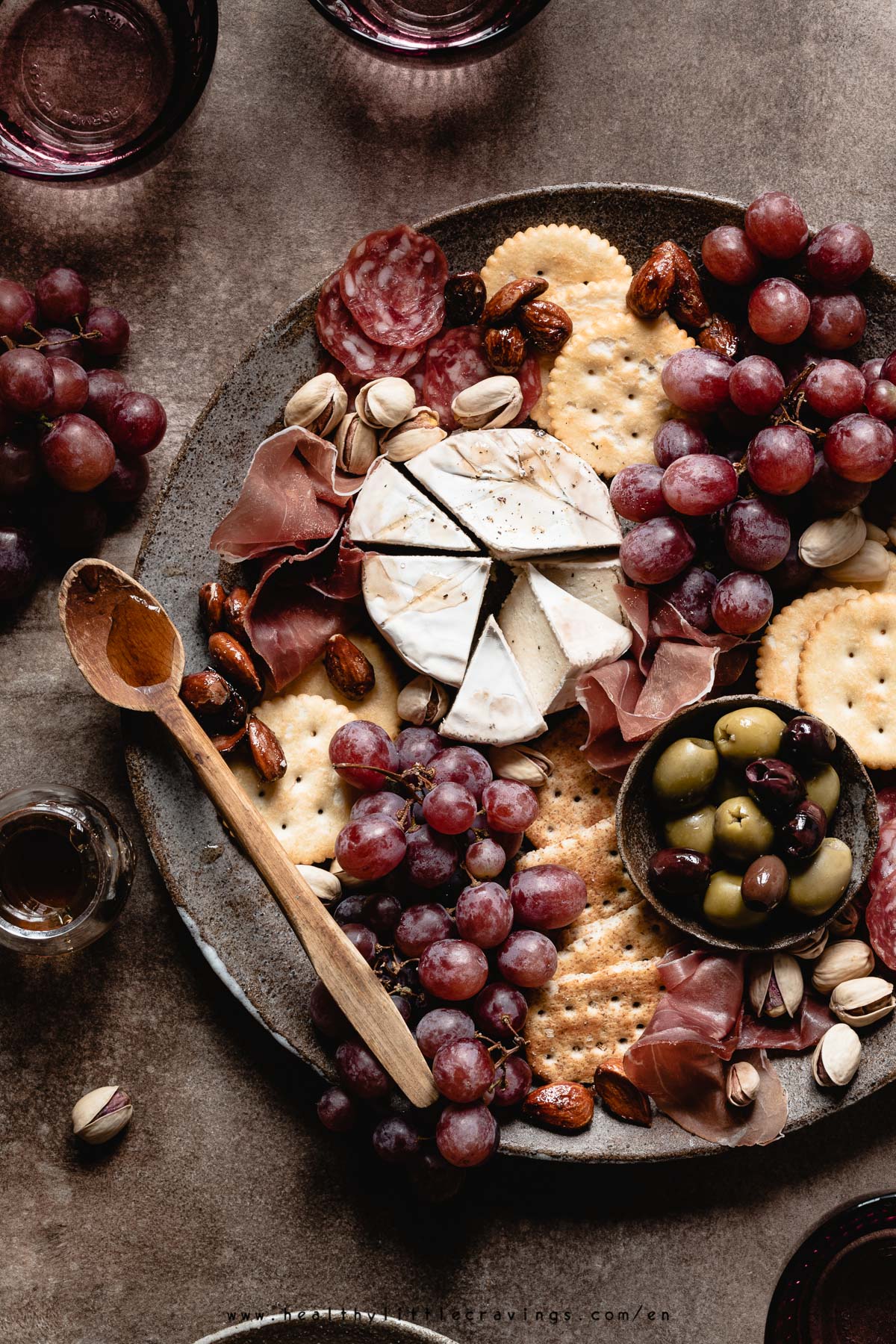 closeup photo of a charcuterie cheese board with vegan cheese