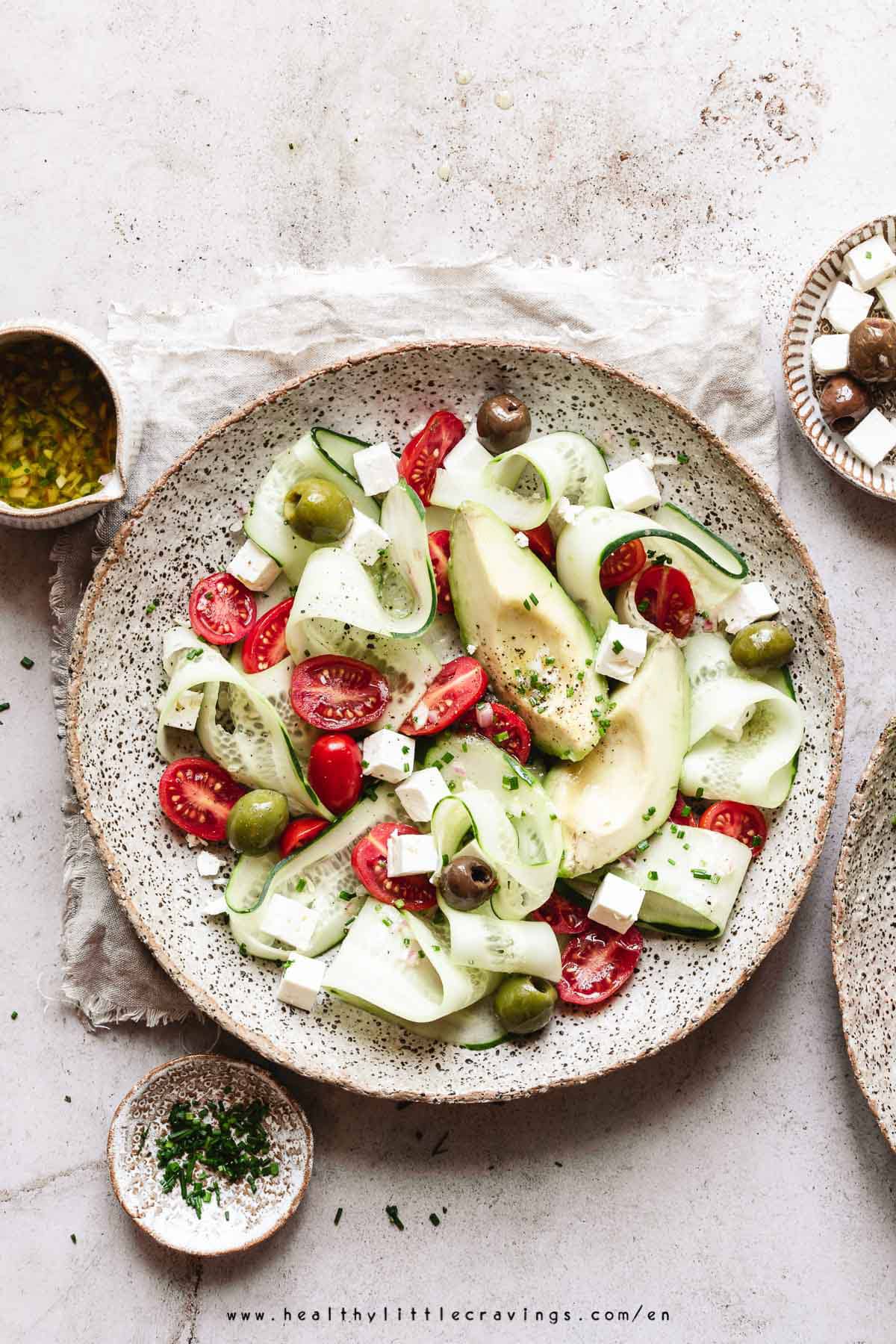 Wide scene with cucumber feta tomato salad