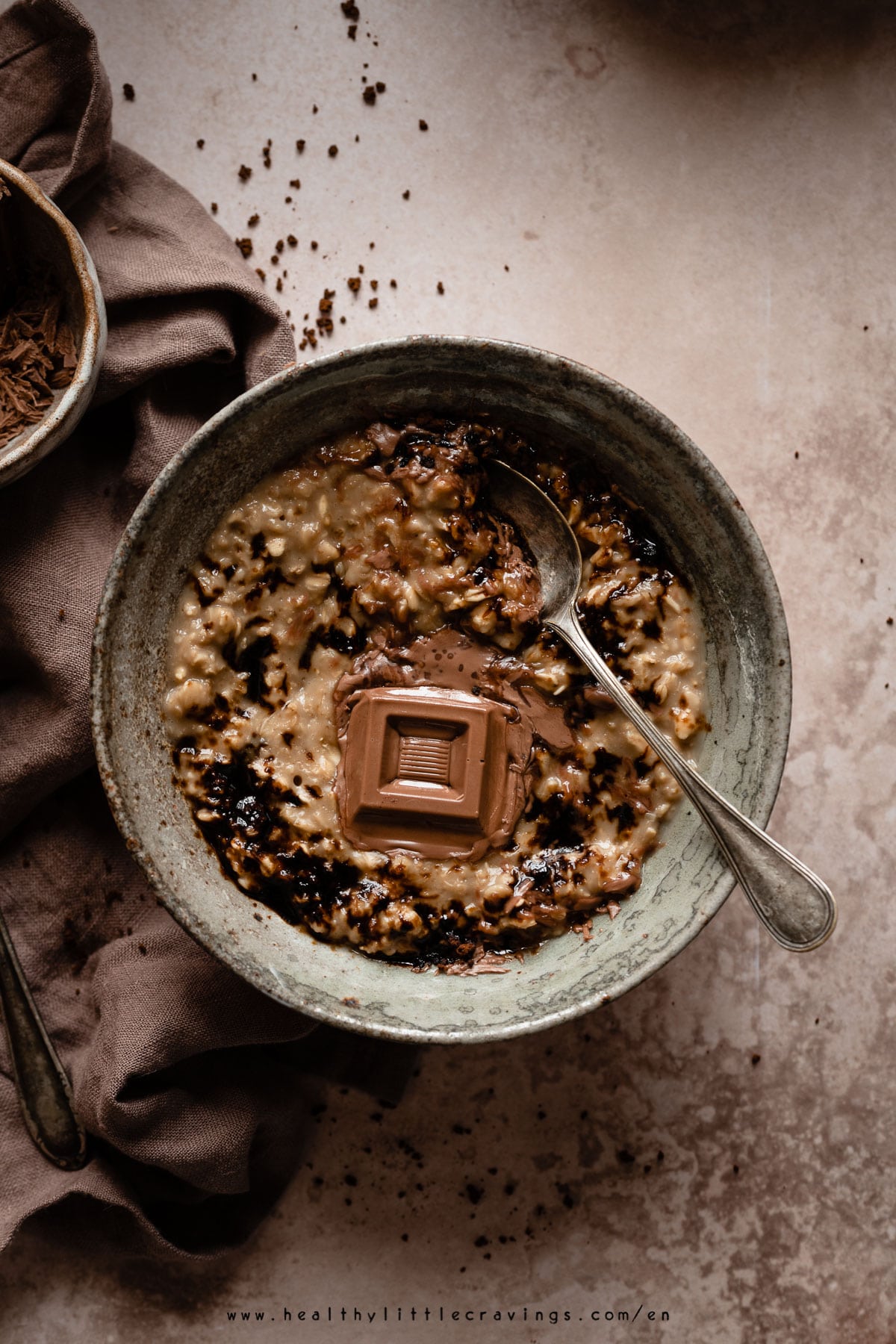 Oatmeal with coffee and a piece of chocolate on top.